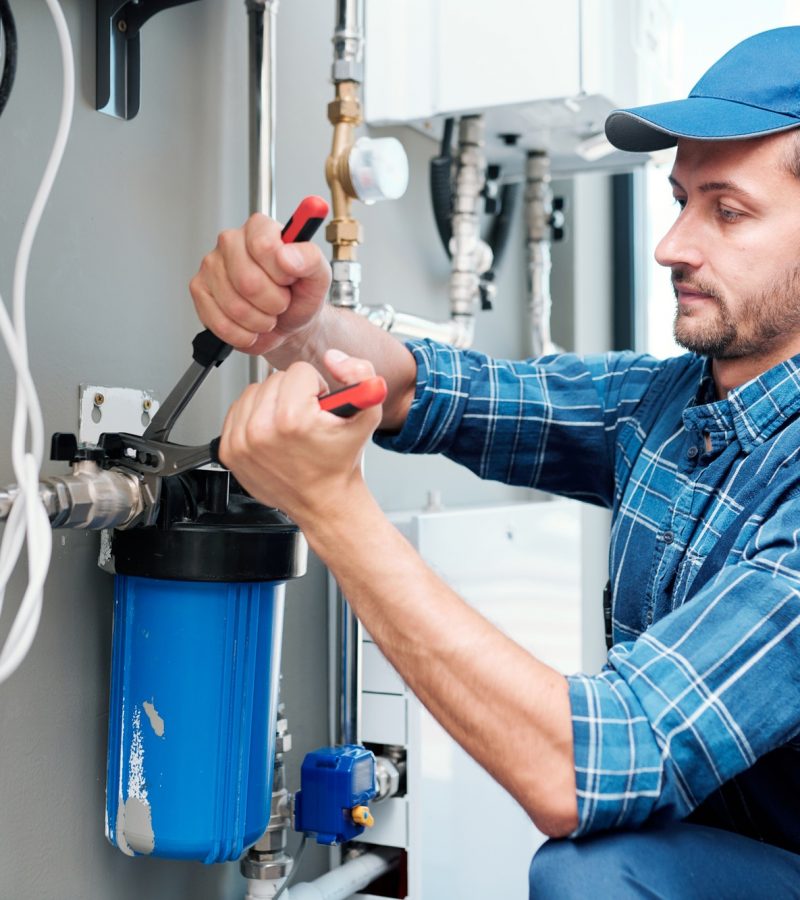 young-plumber-or-technician-installing-or-repairing-system-of-water-filtration.jpg